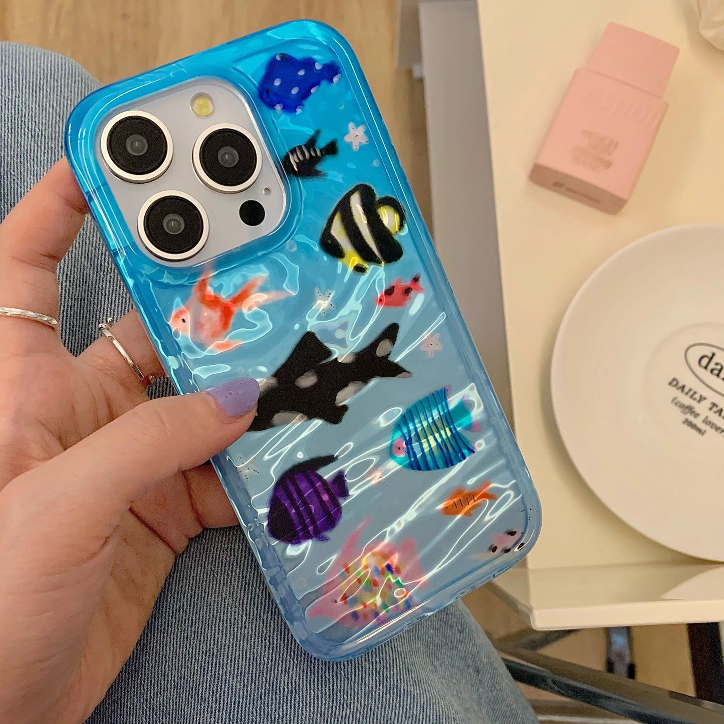 Korean-inspired ripple texture phone case featuring adorable aquatic fish design. Stylish and protective, it safeguards your iPhone from scratches while adding a cute, playful look.