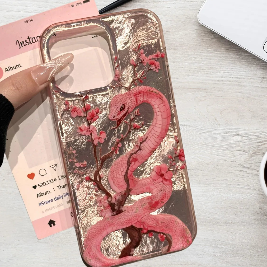 Elegant plum blossom and pink snake illustration phone case for iPhone. Combines artistic design with reliable protection against scratches and everyday wear.